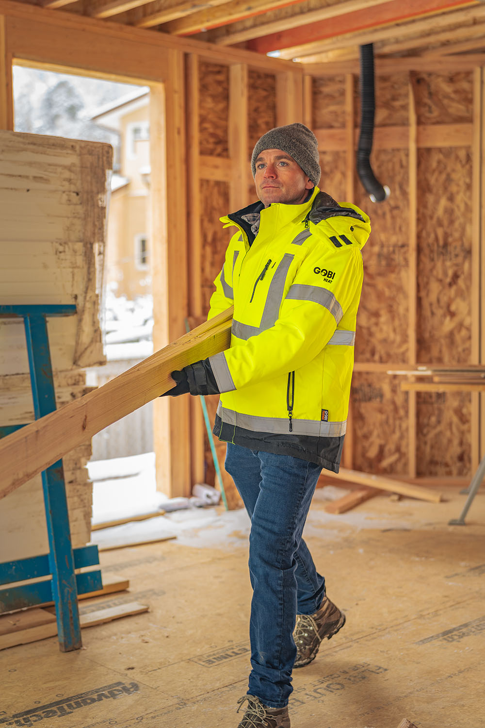 Worker wearing Gobi heated workwear in a cold construction environment