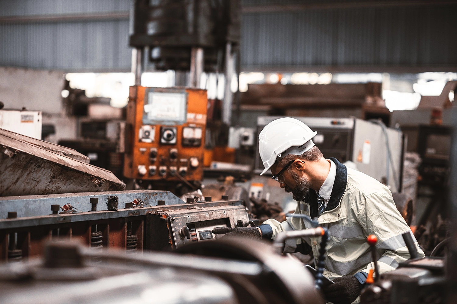 Industrial worker operating metalworking equipment