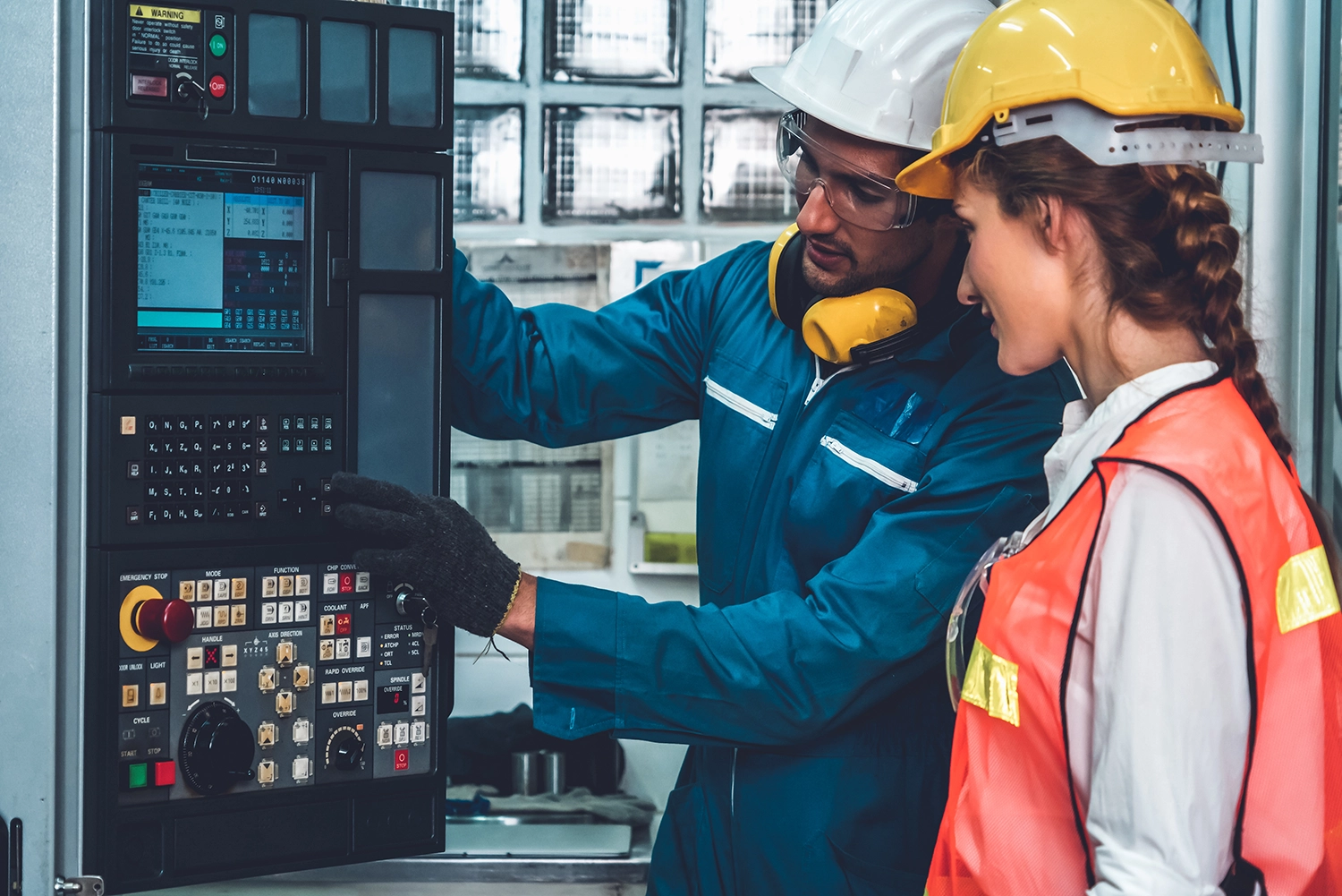 Industrial workers reviewing machine controls during product training